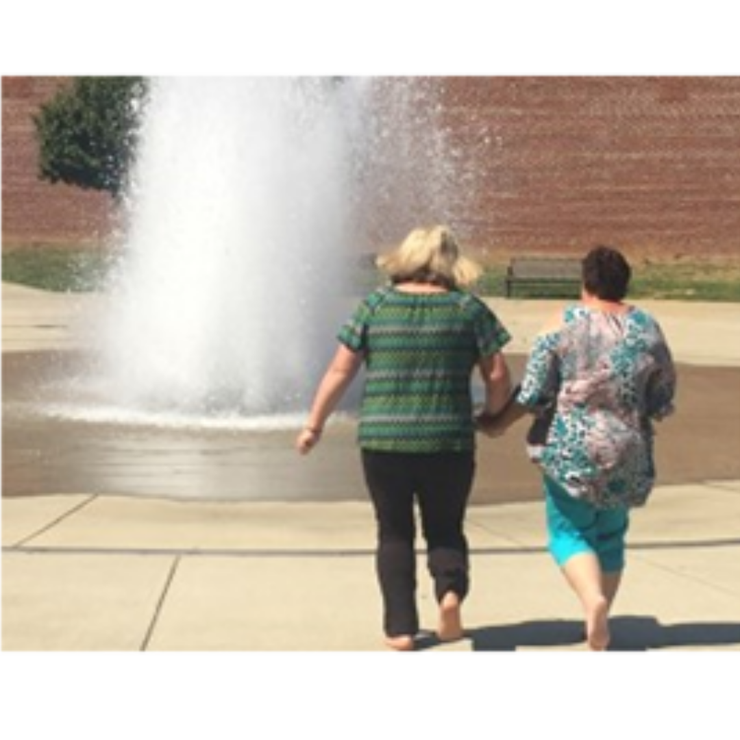 Judy and another woman walking into a fountain after her guardianship was terminated.