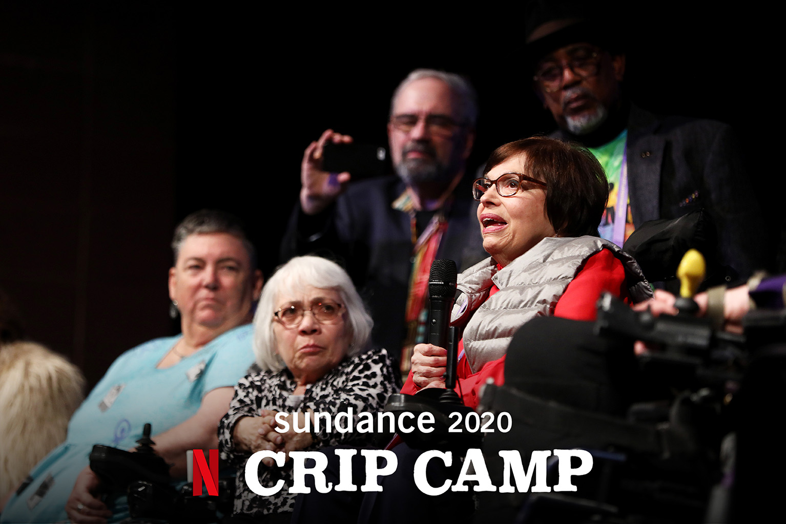 Judy on stage holding a microphone. White text reads "Sundance 2020 Crip Camp" with the Netflix Logo.