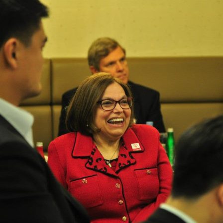 Obama Administration Judy smiling in a room full of people.