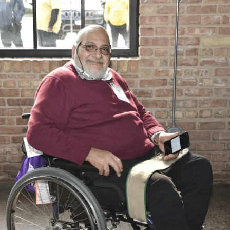 Jorge Pineda in his wheelchair smiling at the 2023 Access Living gala