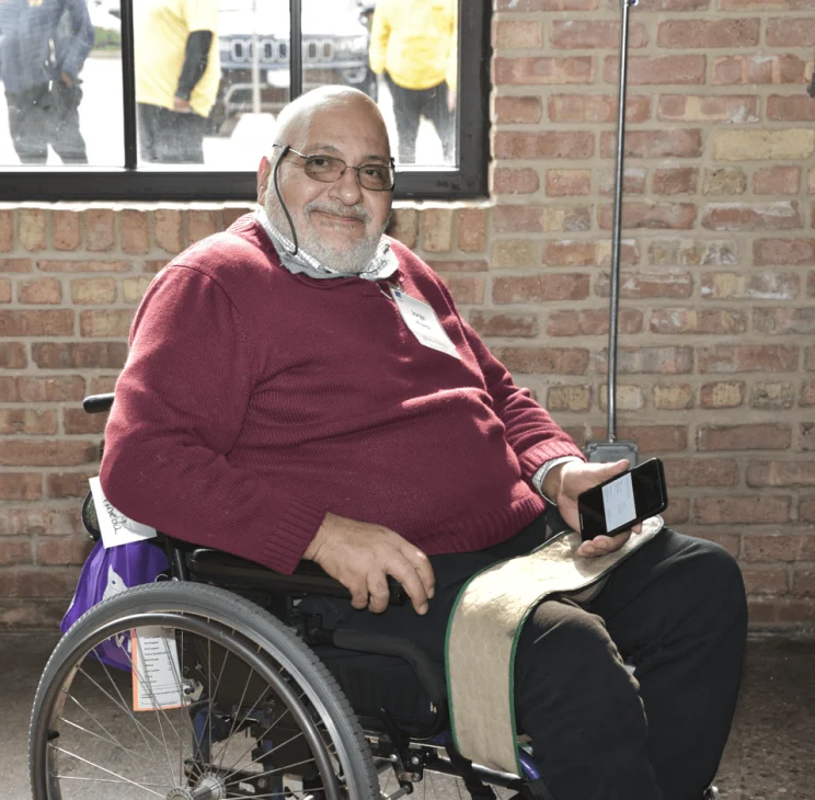 Jorge Pineda in his wheelchair smiling at the 2023 Access Living gala